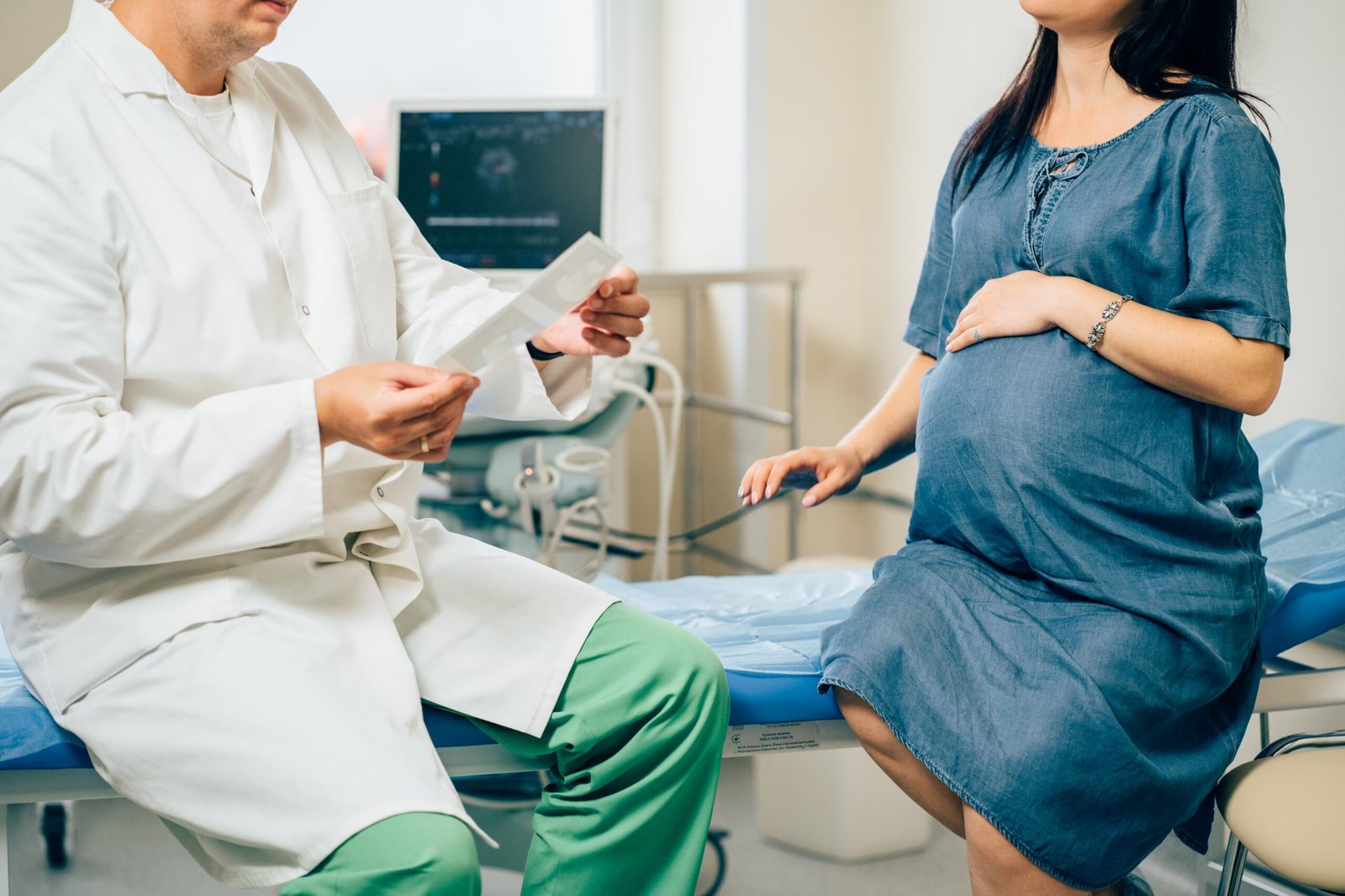 A warm, welcoming medical office setting with a pregnant woman sitting across from a caring, attentive doctor. Soft natural lighting filters through large windows, creating an atmosphere of trust and open communication. The doctor's expression is reassuring as they lean in, gesturing gently while explaining details of the patient's care plan. The woman's posture is relaxed, her face filled with a mix of curiosity and confidence as she actively listens. The overall scene conveys a sense of collaboration and partnership between the healthcare provider and their patient navigating the journey of a high-risk pregnancy.